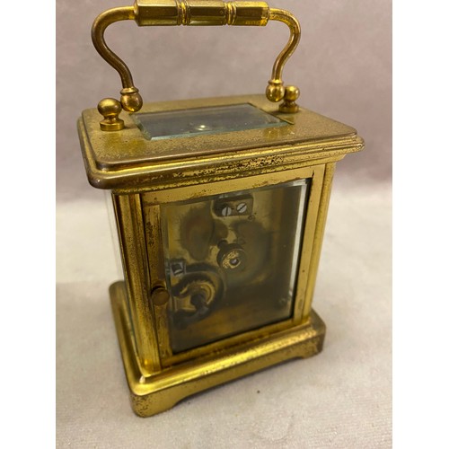 308 - A carriage clock, white enamel dial, French movement, in a brass lacquered and glass case, complete ... 