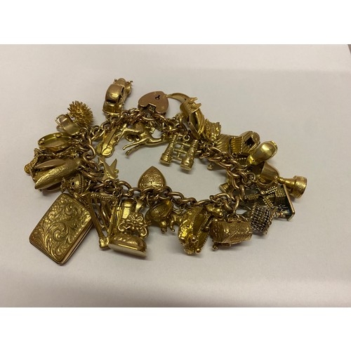 269 - A 9ct. gold bracelet hung with many 9ct. gold charms including seal, ballet slippers, gondola etc..