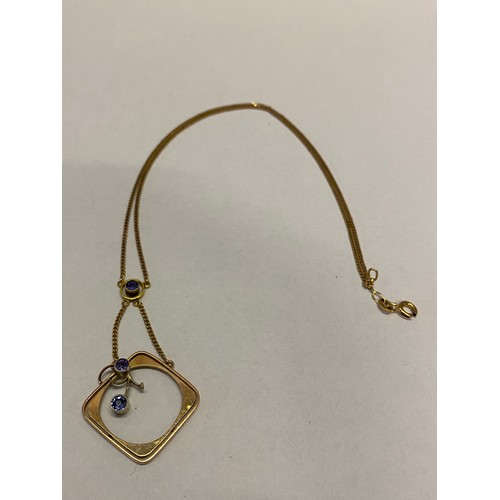 243 - A square 9ct. gold pendant set with two coloured amethysts, on a 9ct. gold chain with amethyst colou... 