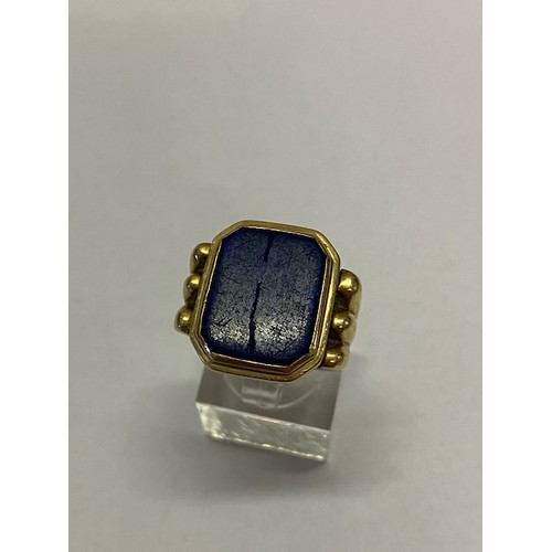 249 - A 14kt. gold signet ring set with lapis lazuli