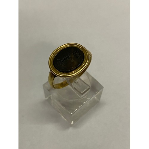 273 - A Georgian gold ring, the top set with hardstone seal, the shank dated June 7th 1814