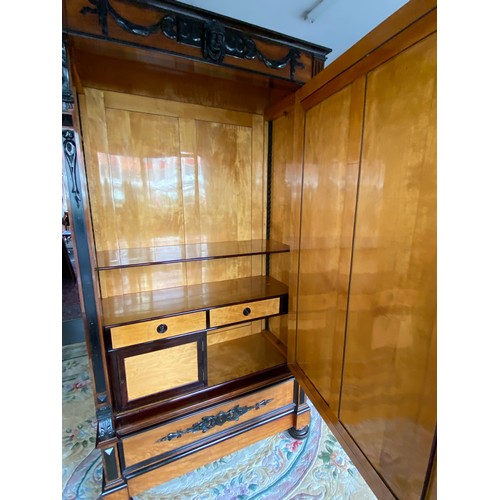 66 - A 19th Century French rosewood veneered wardrobe, the cornice with mask and ribbon decoration, mirro... 