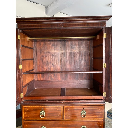 58 - A Georgian mahogany linen press, the upper part with dentil cornice, fitted two panelled doors with ... 