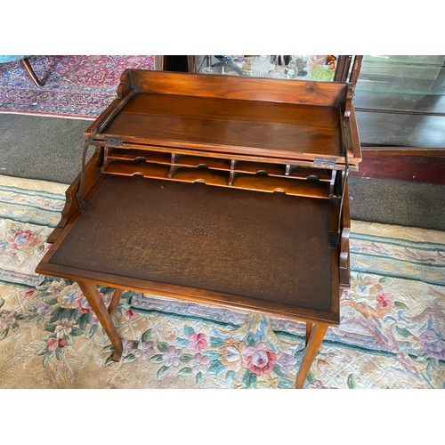 37 - A reproduction mahogany writing table with folding top, on square legs - 29in. wide