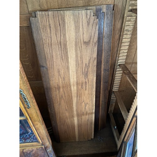 40 - A reproduction Continental walnut veneered bookcase fitted three glass and panelled doors enclosing ... 