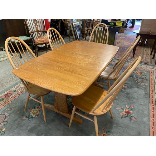 82 - An Ercol blonde elm refectory table with extending top, on trestle ends - 60in. x 36in. and five Erc... 