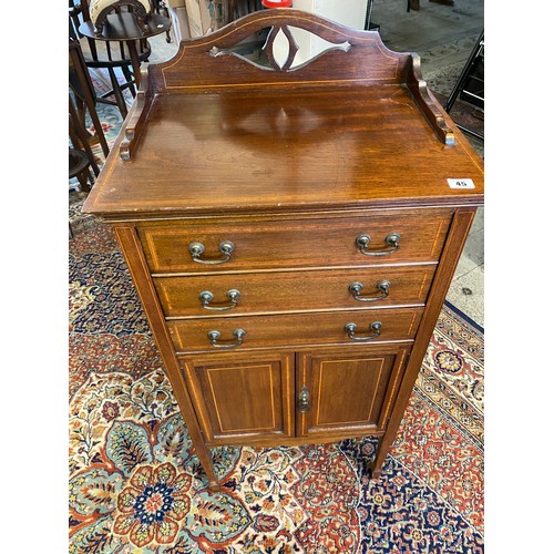 45 - An Edwardian mahogany and satinwood inlaid music cabinet, the low raised back with pierced gallery a... 