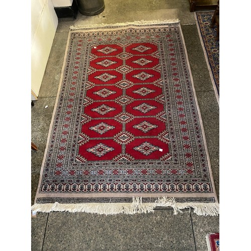 1 - A Bokhara rug, red and grey with fourteen medallions to the centre, fringed - 78in. x 52in. and a sm... 