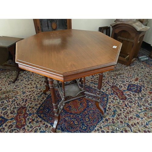 49 - An Edwardian walnut occasional table with octagonal top, on fluted legs terminating in pot castors u... 