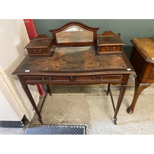 44 - An Edwardian mahogany writing table, low raised back inset bevelled mirror flanked two each side by ... 