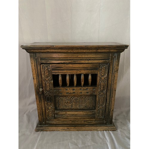 45 - An antique style carved oak ventilated hanging cupboard - 19 1/2in. wide