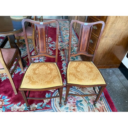 67 - Two Edwardian mahogany and satinwood inlaid bedroom chairs with panelled centre splats, on square le... 