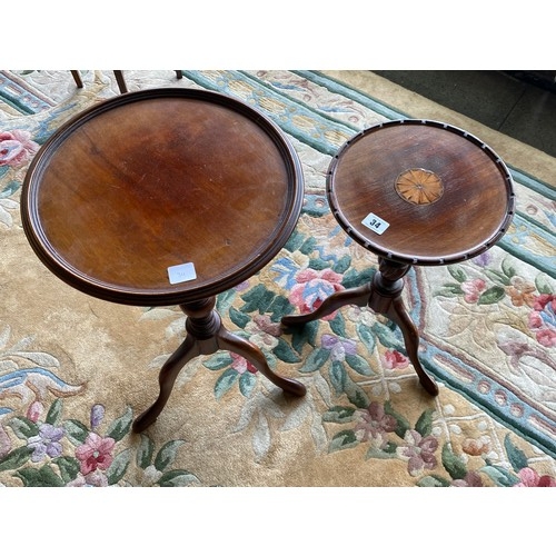 34 - A mahogany wine table with circular top inlaid paterae, on turned column and three downswept legs an... 