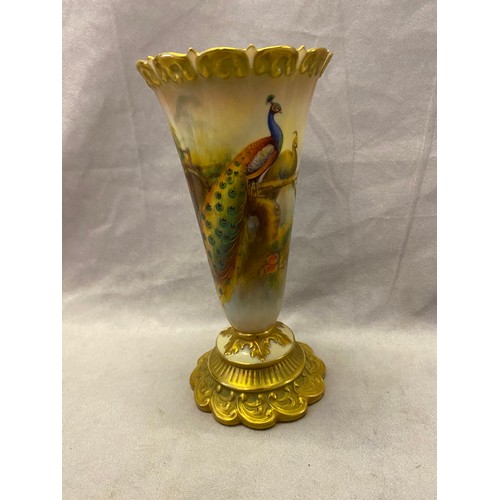 79 - A Royal Worcester vase of trumpet form, shaped gilt neck, painted to the body with a peacock and pea... 