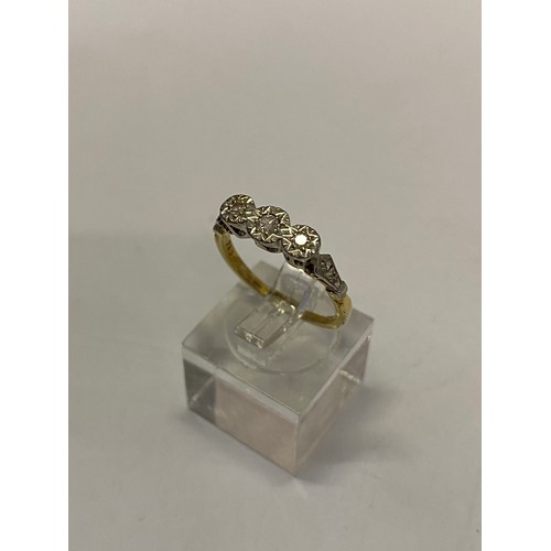 214 - A lady's ring set three diamonds, on an 18ct. gold and platinum shank