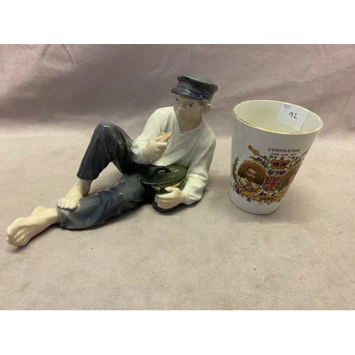 92 - A Royal Copenhagen model of reclining fisherman and a small Coronation mug for George V and Queen Ma... 