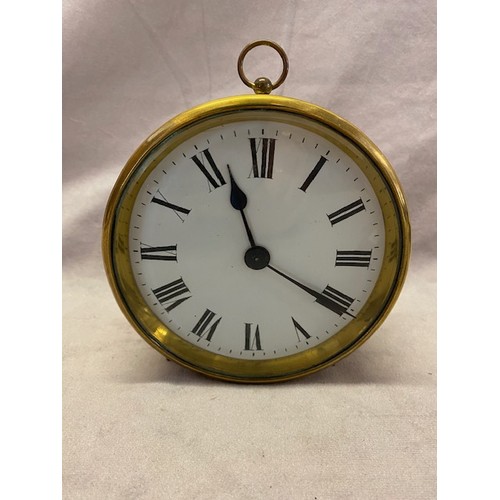 257 - A clock with white enamel dial, in a brass case, on short feet