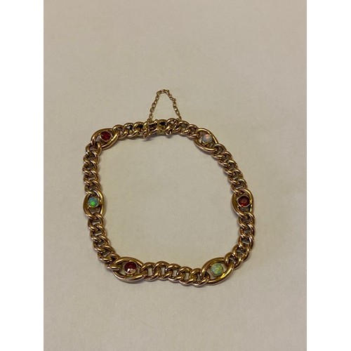 227 - A 9ct. gold bracelet set with opal and garnet spacers