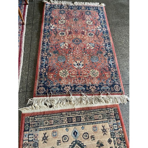 1 - Two rugs, red and blue fields with floral pattern decoration, fringed - 60in. x 39in. approx.