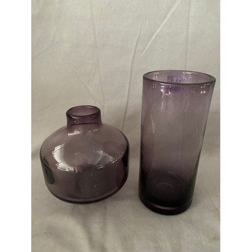 145 - A Wedgwood purple vase of cylindrical form - 8 3/4in. high and a similar Wedgwood vase of squat form... 