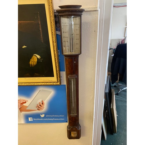 32 - A Georgian stick barometer by Troughton and Simms of London in a mahogany case