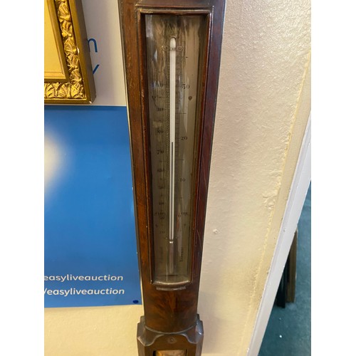 32 - A Georgian stick barometer by Troughton and Simms of London in a mahogany case