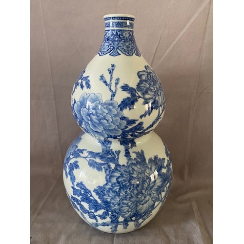 142 - A modern Chinese blue and white double gourd shaped vase decorated flowers - 16in. high