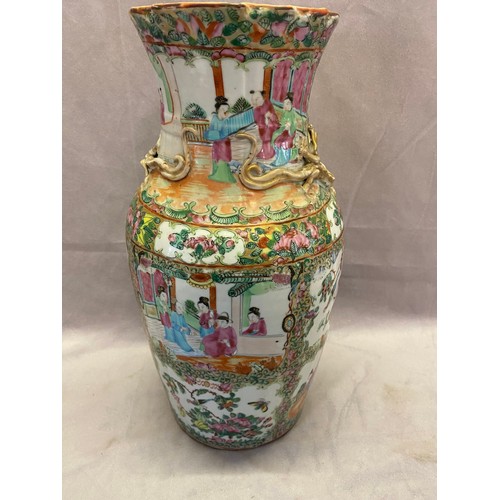 149 - A Cantonese vase with frilled neck, applied gilded lizards, decorated in reserves with figures, flow... 