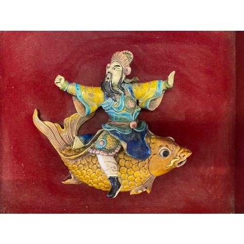 147 - A Chinese roof tile in the form of a warrior seated on the back of a carp - 11in. high and 11in. wid... 