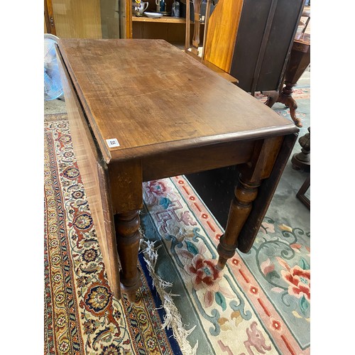 35 - A mahogany dining table fitted two deep drop flaps, on baluster turned legs - 36in. wide