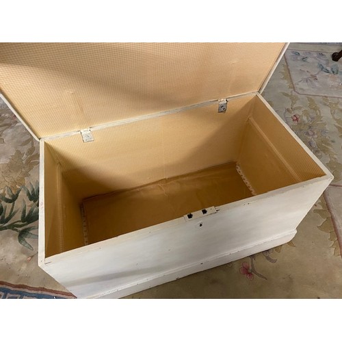 60 - A white painted pine box with hinged lid, end handles, panelled base - 34in. wide