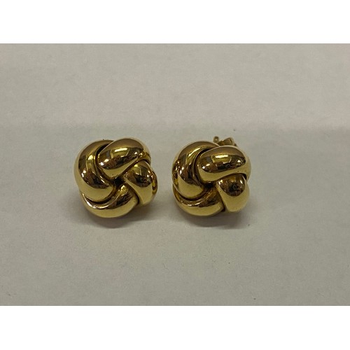 213 - A pair of 18ct. gold knot form earrings