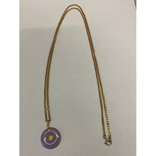 214 - A Chinese circular gold mounted lavender jade hardstone pendant on a long 9ct. gold chain