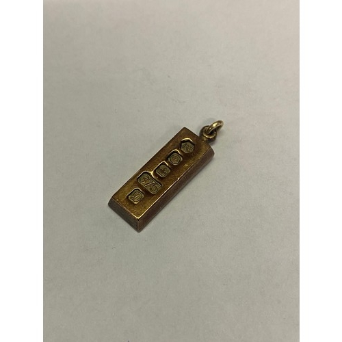 210 - A small 9ct. gold ingot pendant