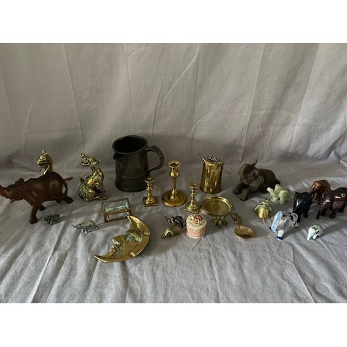 234 - A pewter measure, a collection of elephants, a selection of brass including a dog, moon dish candles... 