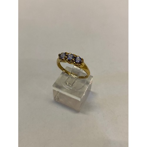 263 - A lady's ring set three tanzanite stones, on a 9ct. gold shank