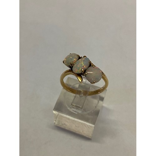 266 - A lady's ring set three opals, on an 18kt. gold shank