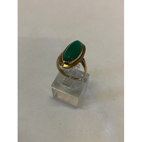 267 - A lady's ring set oval green stone, on a 9ct. gold shank