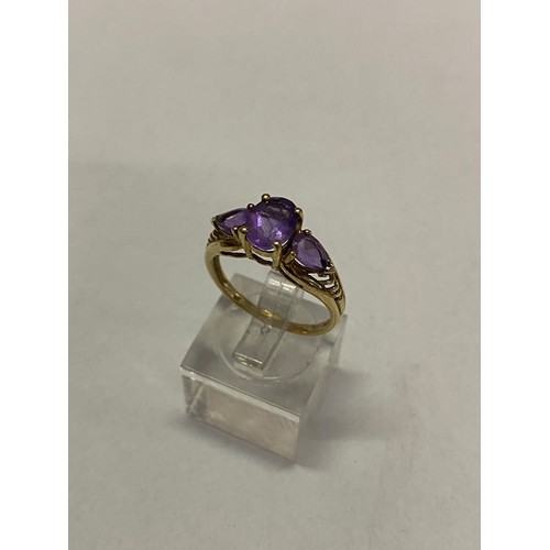 269 - A lady's ring set three amethysts on a 9ct. gold shank