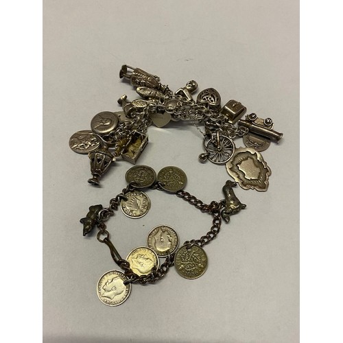 279 - A silver bracelet hung with many charms including canon, yeoman warder, ewer, St Christopher, penny ... 