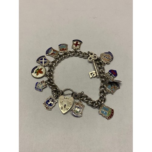 278 - A silver bracelet hung with many charms