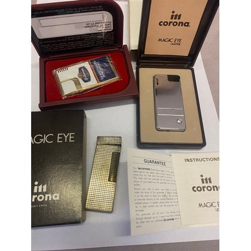 337 - A Dunhill cigarette lighter in a white metal case, a Corona Magic Eye cigarette lighter, boxed and a... 