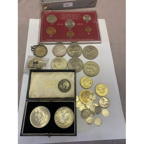 338 - A cased set of 1935 George V silver crown, an Elizabeth II silver five shilling coin (HT Lamb and Co... 