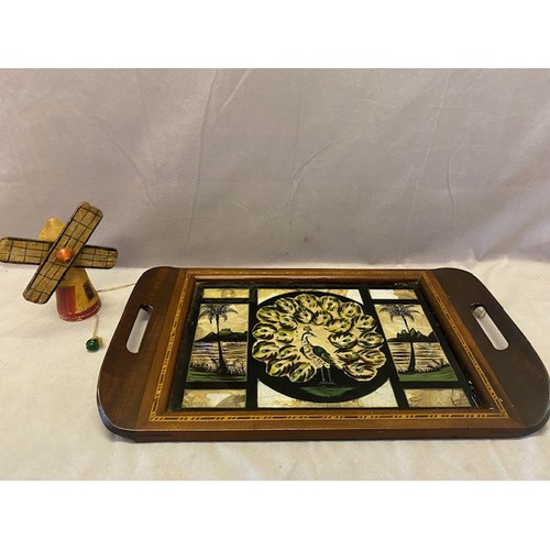 341 - A tray with butterfly wing decoration and a wooden toy in the form of a windmill