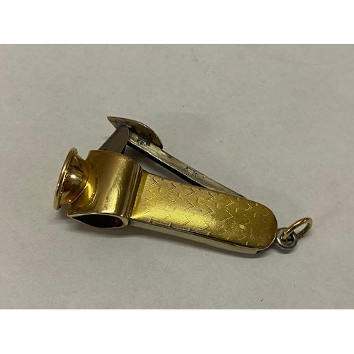 303 - A cigar cutter mounted in engine turned gold coloured metal