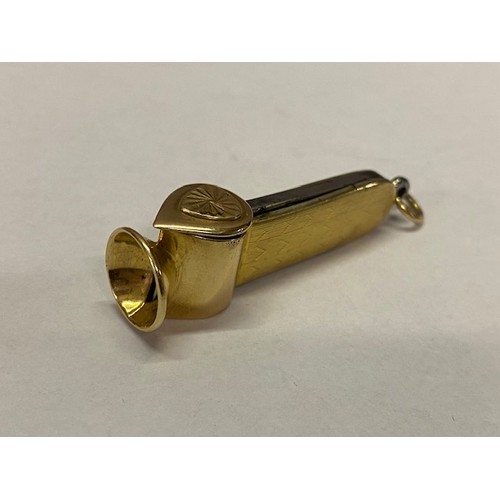 303 - A cigar cutter mounted in engine turned gold coloured metal