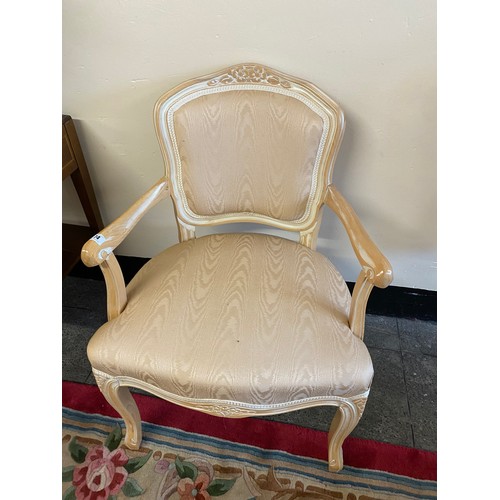 31 - A reproduction limed oak fauteuil with peach seat and back, on cabriole legs