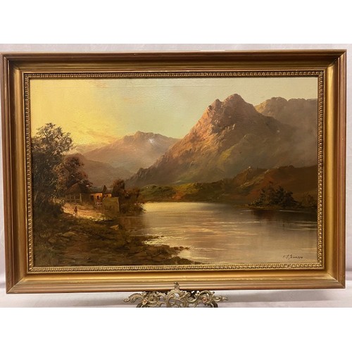 16 - F.E Jamieson.  A signed oil on canvas - Lake and mountain scene at dusk, gilt framed - 19in. x 29in.