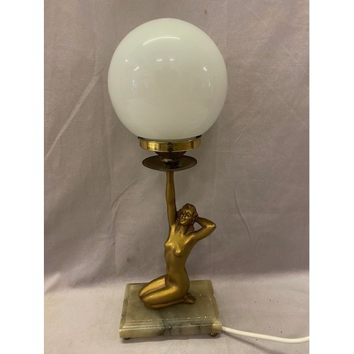 344 - An Art Deco spelter tablelamp base in the form of a kneeling lady holding a glass globular shade, on... 