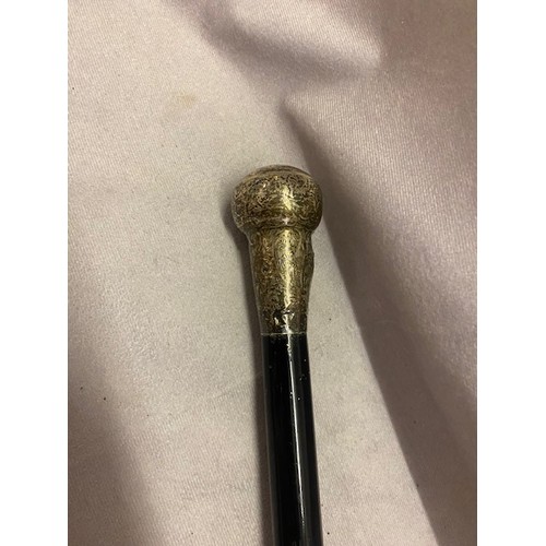 349 - An ebonised cane with plain silver knop